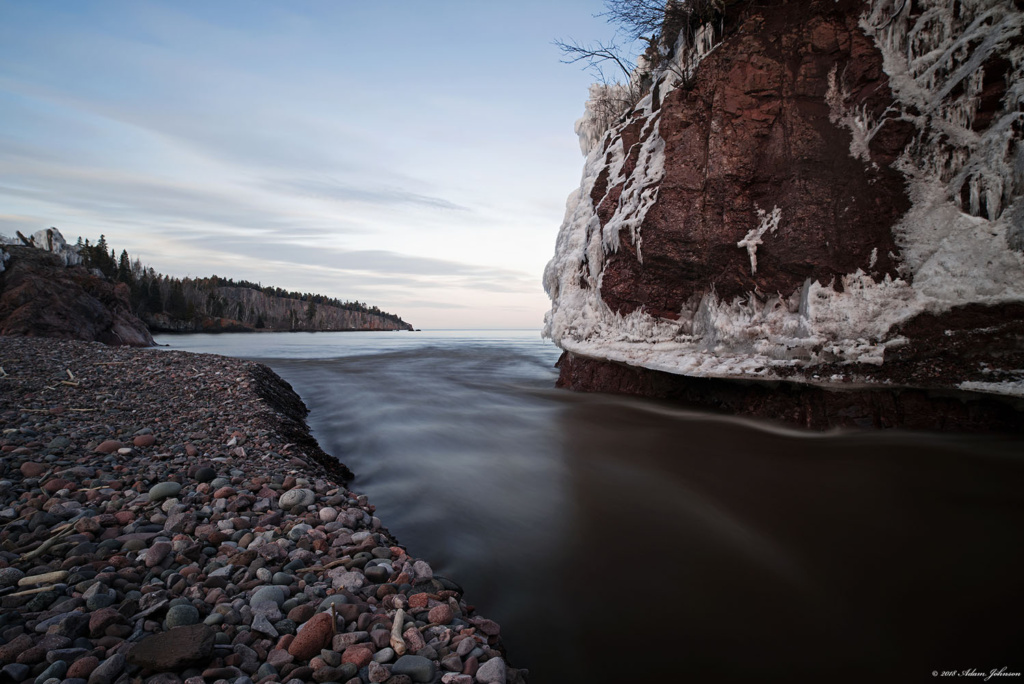 Baptism Riiver flowing into Lake Superior and ice covered rocks following two-day winter storm