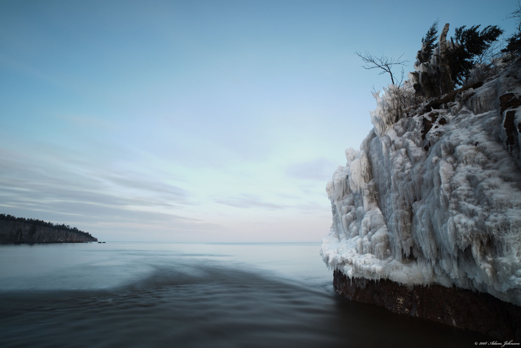 Twilight and ice covered rocks at the mouth of the Baptism River - Tettegouche State Park