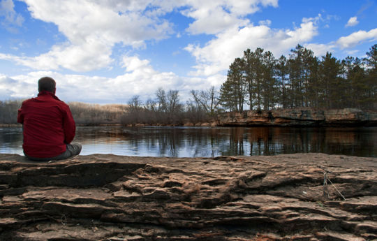 Sitting on an earthen dam along the Kettle River | Big Spring Falls Banning State Park