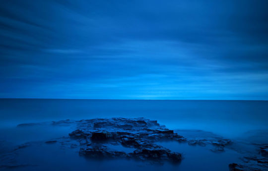 Long exposure of Lake Superior shoreline and sound sky after sunset at Split Rock Lighthouse State Park