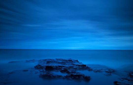 Long exposure of Lake Superior shoreline and sound sky after sunset at Split Rock Lighthouse State Park