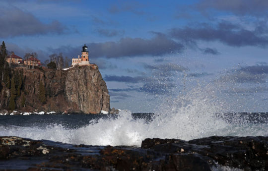 Waves breaking on the shoreline and Split Rock Lighthouse in spring | Split Rock Lighthouse State Park