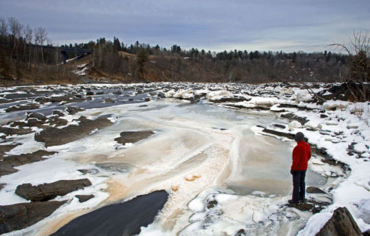 Standing on rocks next to the frozen Saint Louis River | Jay Cooke State Park
