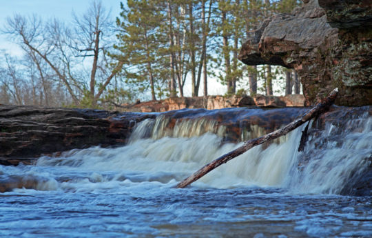 Kettle River flowing over earthen dam at Big Spring Falls | Big Spring Falls Banning State Park