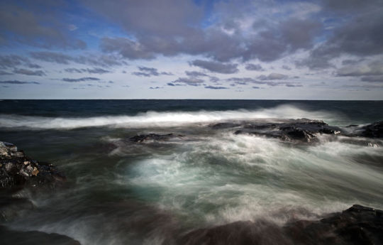 Waves rolling over rocks on a windy spring afternoon | Split Rock Lighthouse State Park