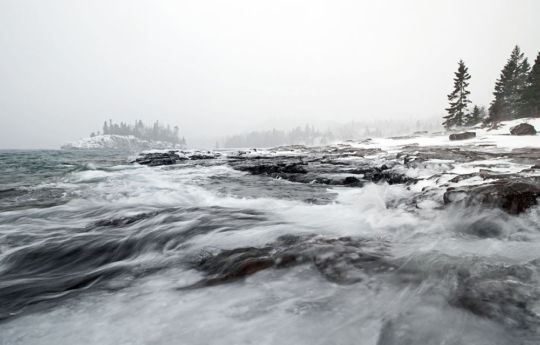 Split Rock Lighthouse State Park - Waves coming in on the rocky shoreline if Split Rock Lighthouse State Park in winter