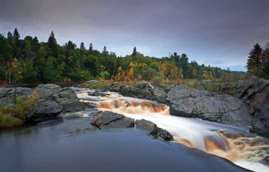 Cascading falls on the Saint Louis River as leaves begin to change at Jay Cooke State Park