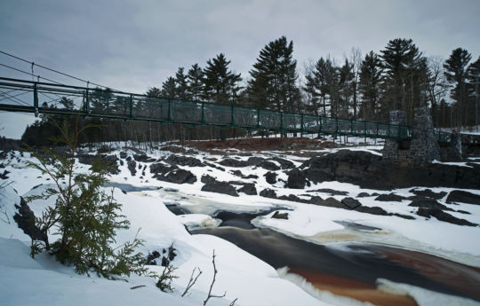 Swinging Bridge in winter with snow and ice on the Saint Louis River | Jay Cooke State Park