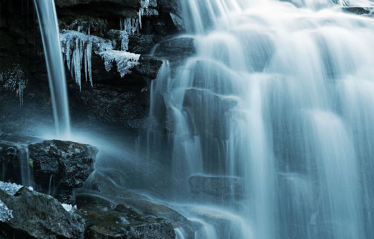 Water flowing and ice building on rocks of Upper Minneopa Falls | Minneopa State Park