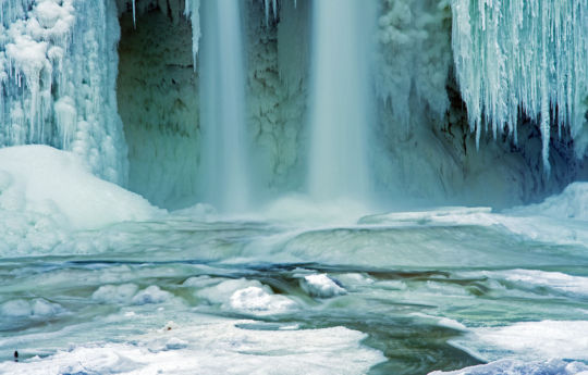 Water flowing over frozen Minneopa Creek below the falls | Minneopa State Park