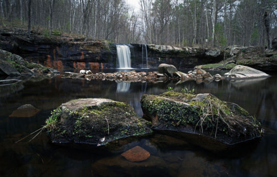Rocks exposed by low water below Wolf Creek Falls in spring | Banning State Park