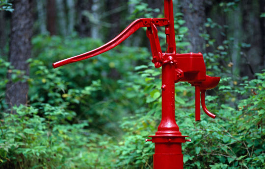 Freshly painted red hand pump in the Ridge Campground | Zippel Bay State Park