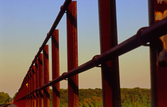 Looking down the catwalk to the Arcola Soo Line Bridge at sunset