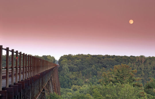 Full moon rising over the Arcola Soo Line bridge in early September