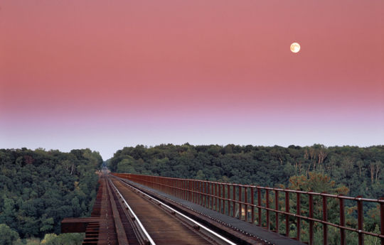 Full moon rising over the Arcola Soo Line bridge in early September