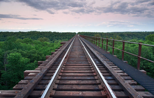 Young couple venturing onto the Arcola Soo Line Bridge at sunset