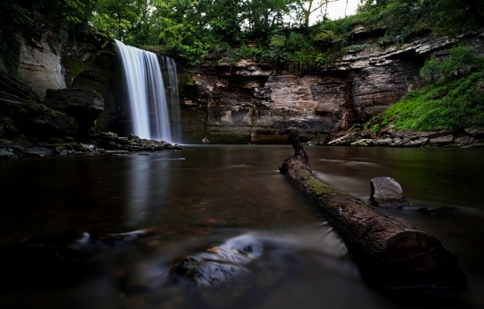 "Minneopa Falls in Early August" Log resting in low water of Minneopa Creek below Minneopa Falls | Minneopa State Park