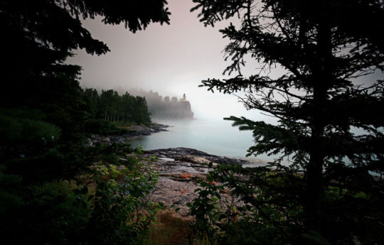 Split Rock Lighthouse State Park | Split Rock Lighthouse on a foggy evening. With fog and rain I had the beach to myself for much of the afternoon. With light fading I walked to the treeline and as I turned found the trees a perfect frame for Split Rock Lighthouse in the background.